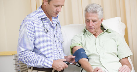 Male patient having blood pressure test with doctor